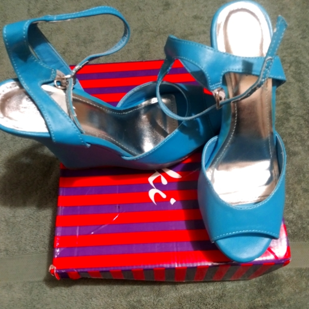 A pair of turquoise peep toe wedges